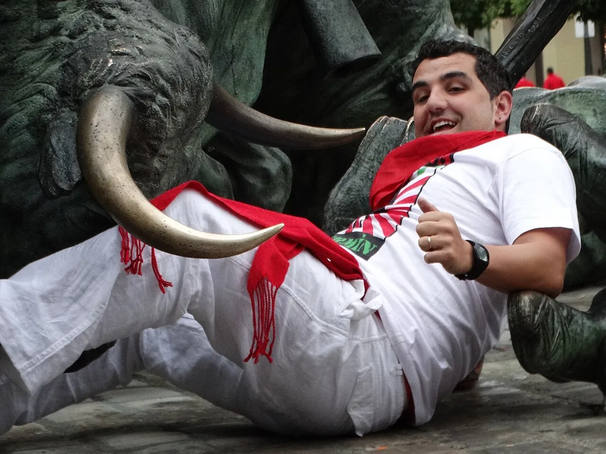 Runners and bulls on a barricaded Pamplona street during the morning encierro — 2